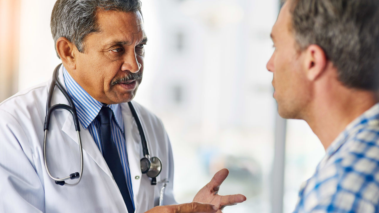 A doctor talking to a male patient.