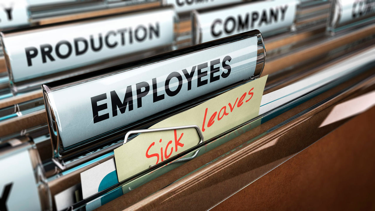 A file folder with the words employees sick leave on it.