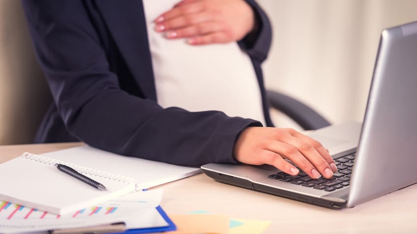 Pregnant woman at laptop