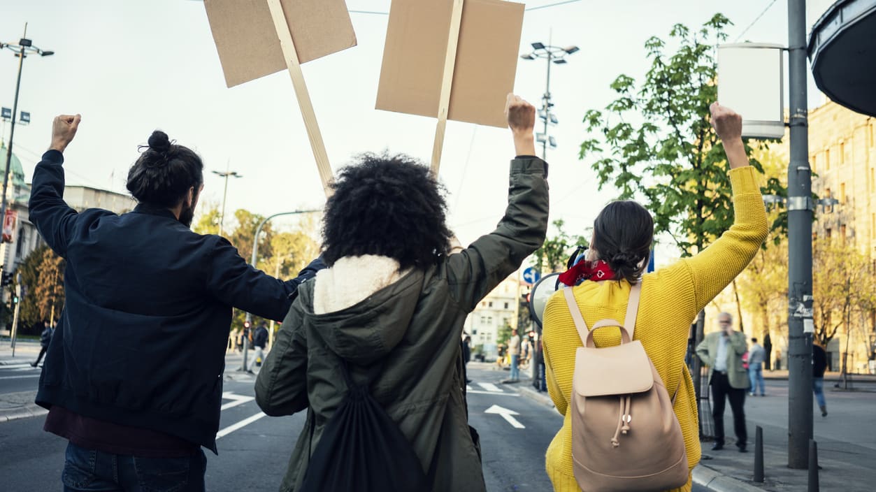 A group of people holding placards in the street.