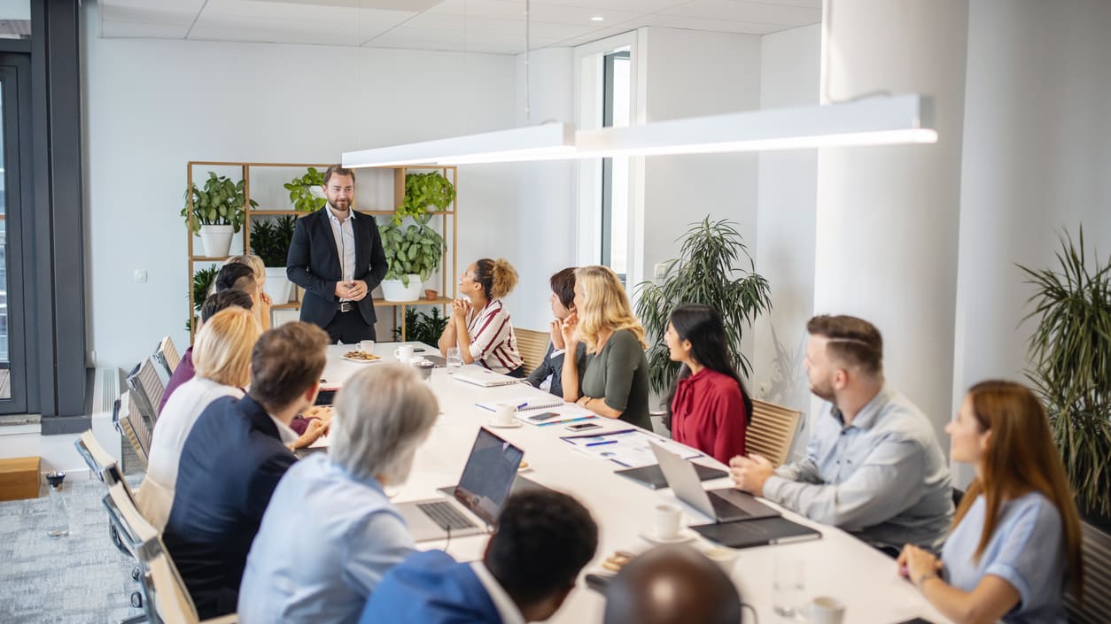 A group of business people sitting around a conference table.