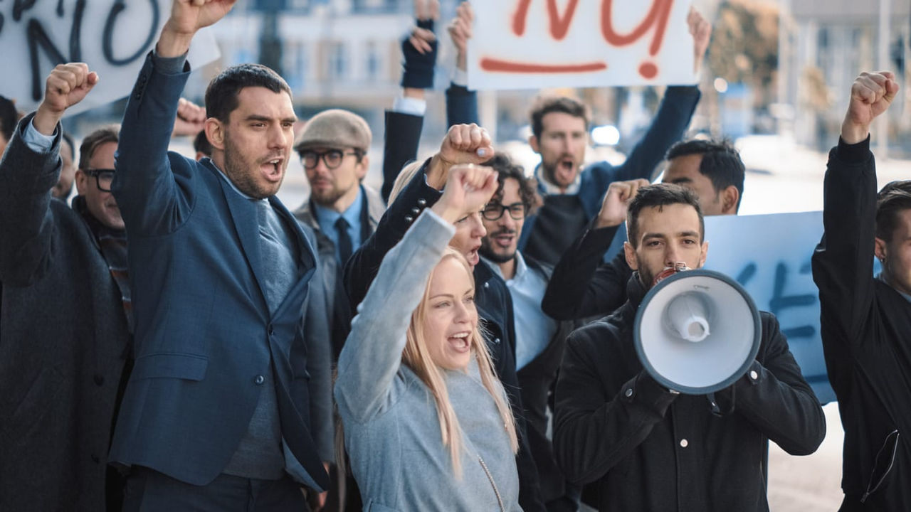 A group of people holding signs and shouting slogans.