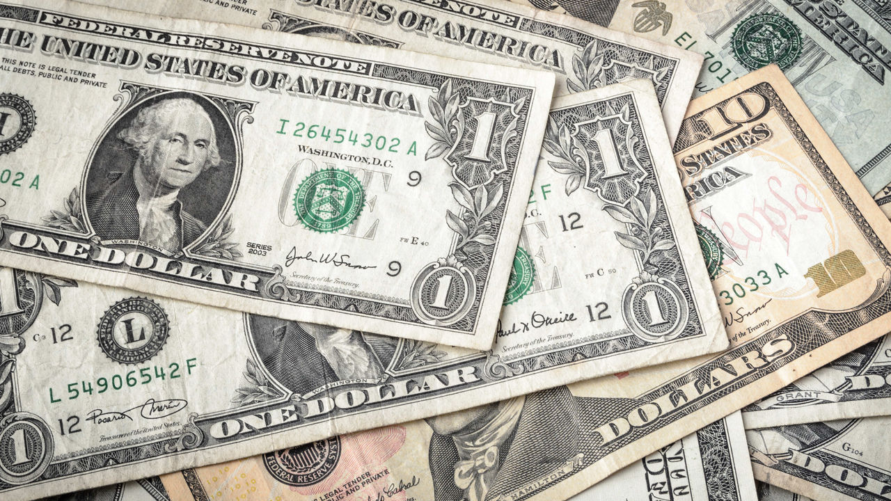 A close up of a pile of us dollar bills.