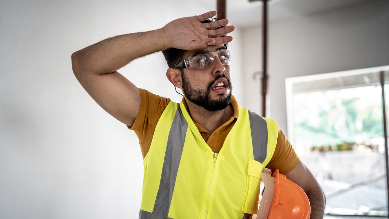 A construction worker wearing a hard hat and safety vest.