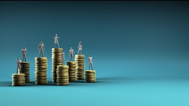 A group of people standing on top of stacks of coins.