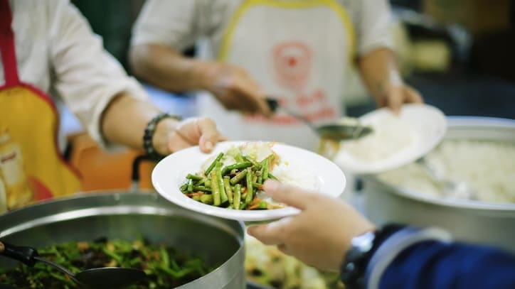 A group of people serving food to each other.