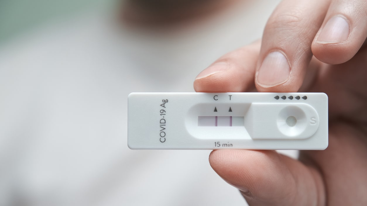 A man is holding a blood test device.