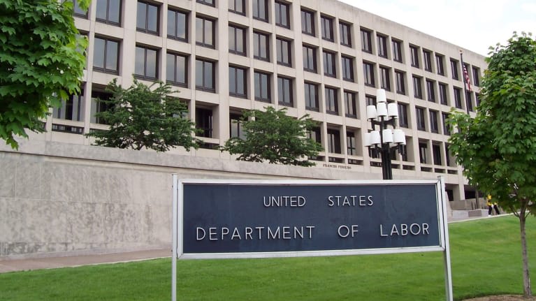 The department of labor sign is in front of a building.