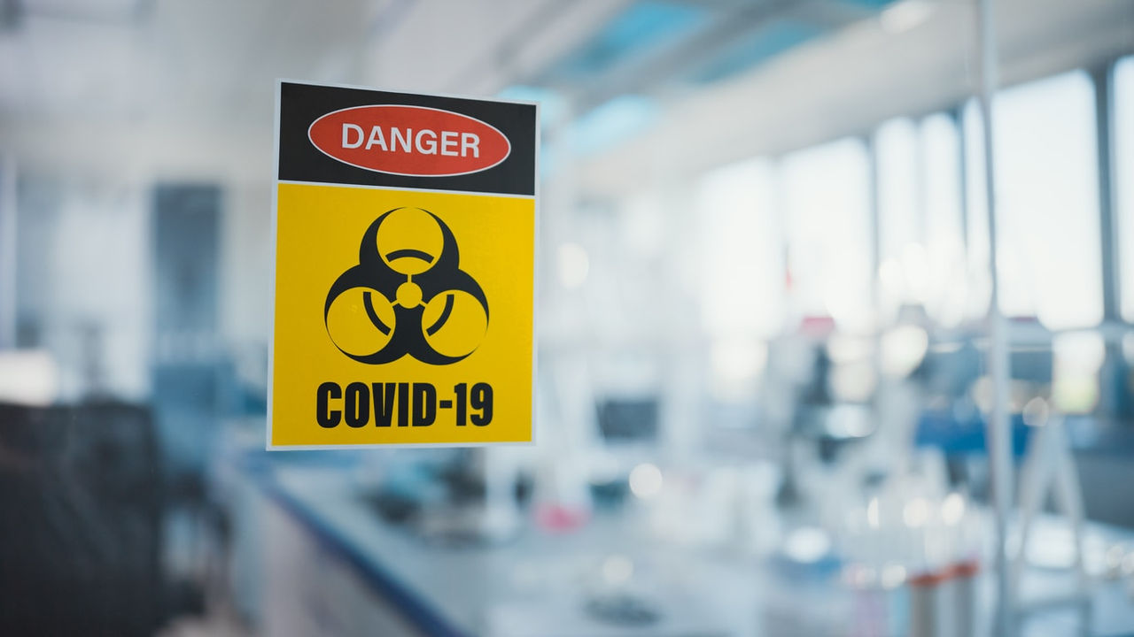 A sign warning of covid-19 in a laboratory.