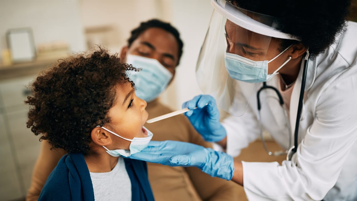 An woman is giving a child a dental checkup.