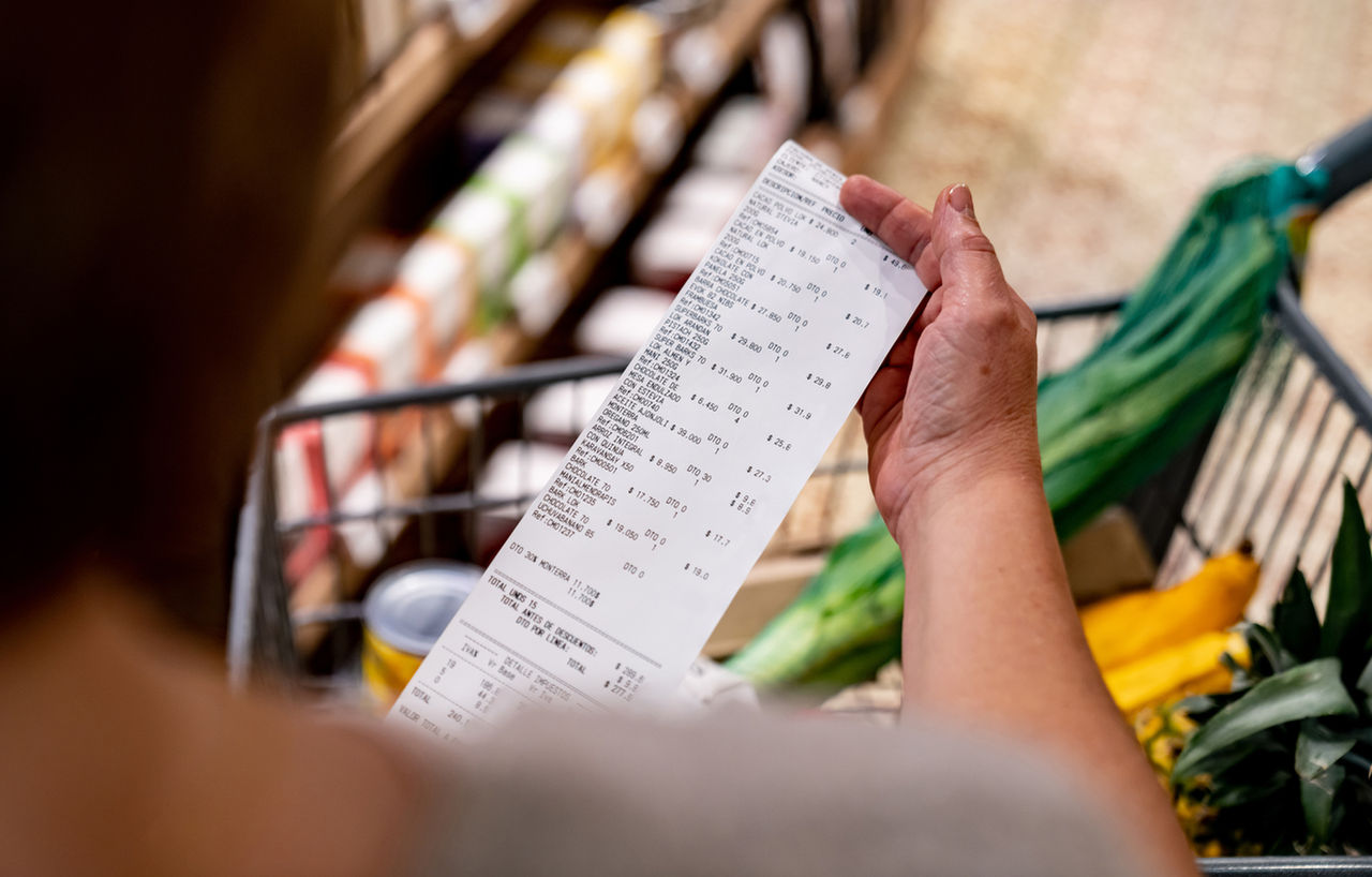 Person looking at receipt at grocery store