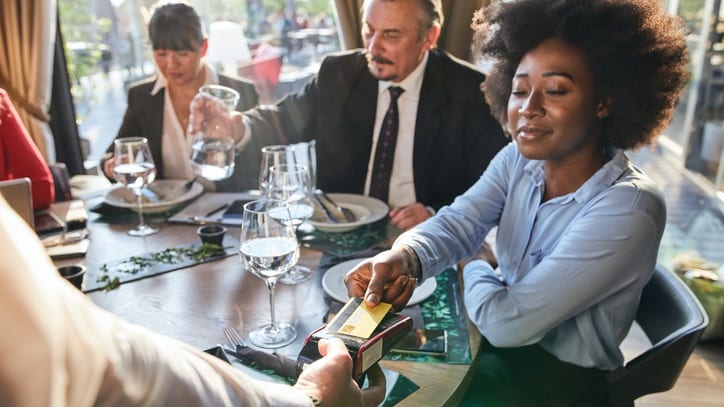 A group of people sitting around a table at a restaurant.