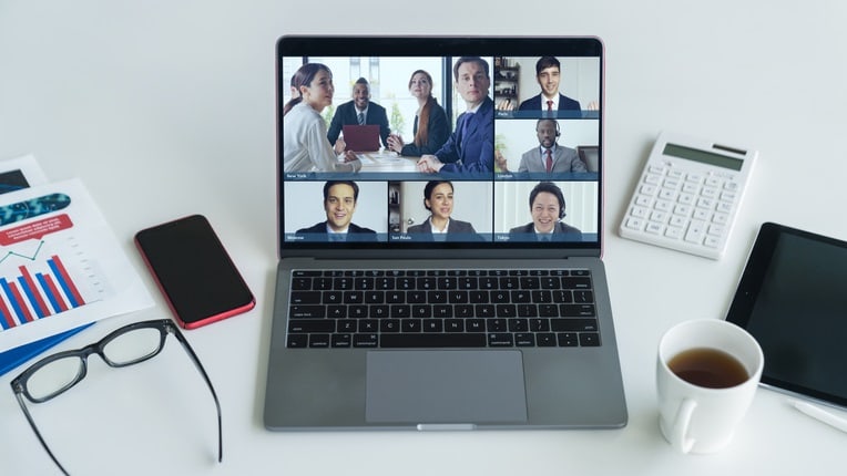 A laptop with a video conference on it.