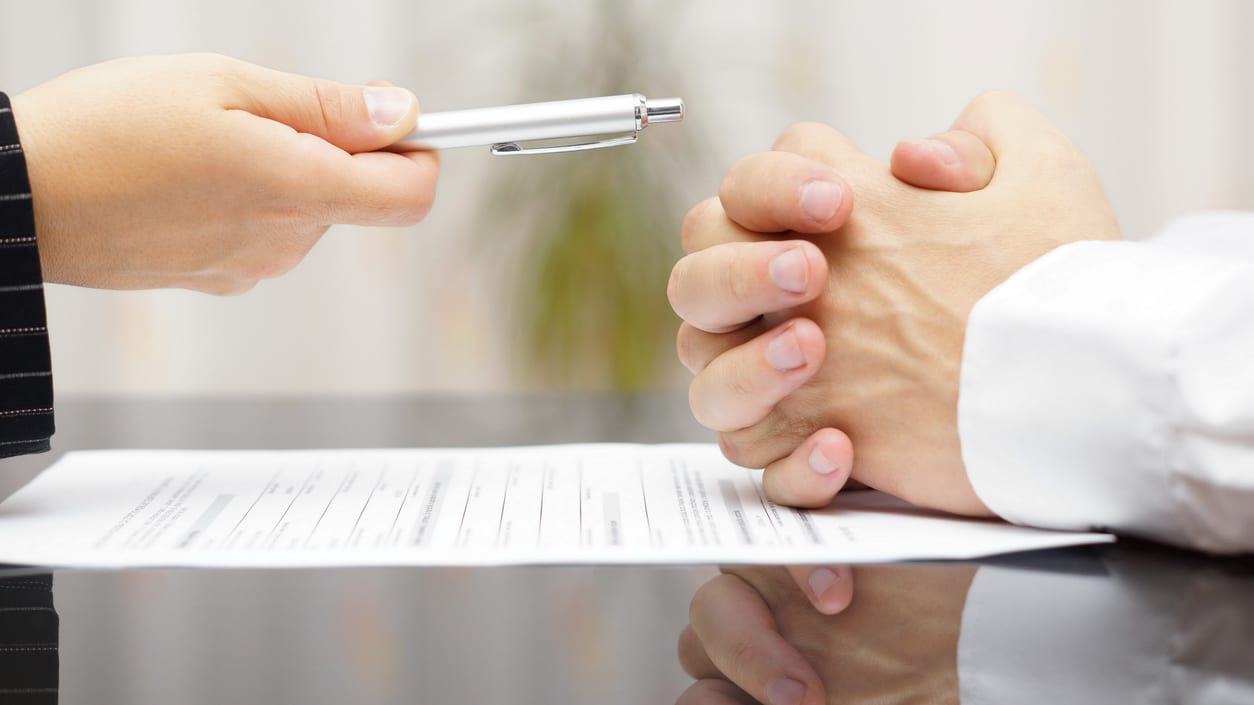 A businessman signing a contract with a pen.