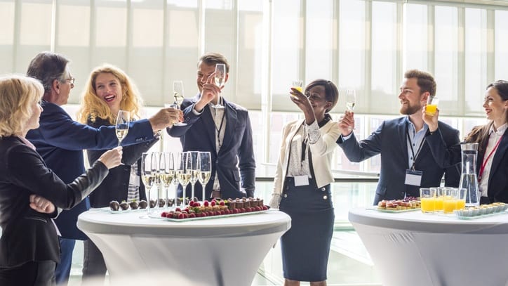 A group of business people toasting at an event.