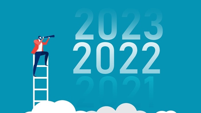 A businessman standing on a ladder with the words 2020 and 2021 on it.