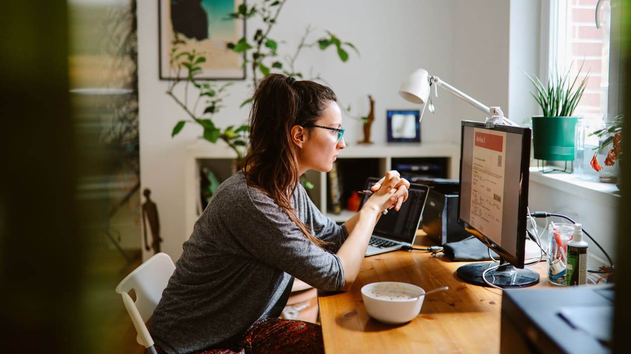 A woman working on her computer in her home office.