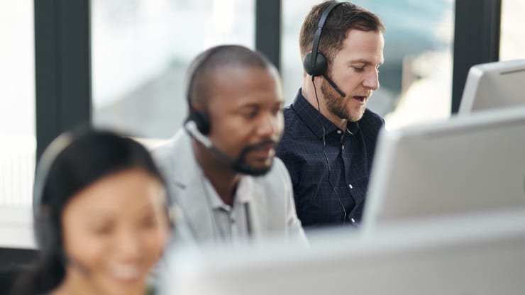 A group of people working in a call center.