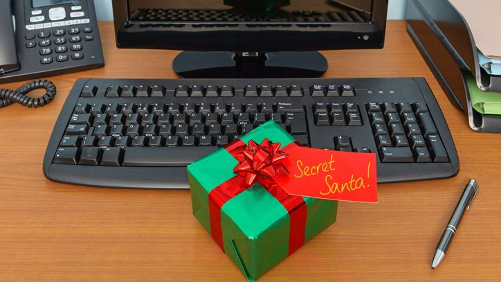 A gift box on a desk next to a computer.
