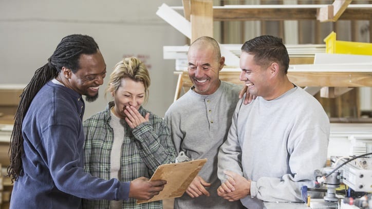 A group of men and women working in a factory.