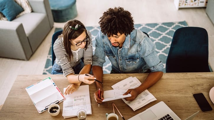 Two young people working together at a table.