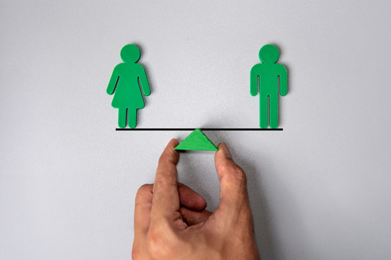 male and female human figure on balancing scale to show equitable development opportunities