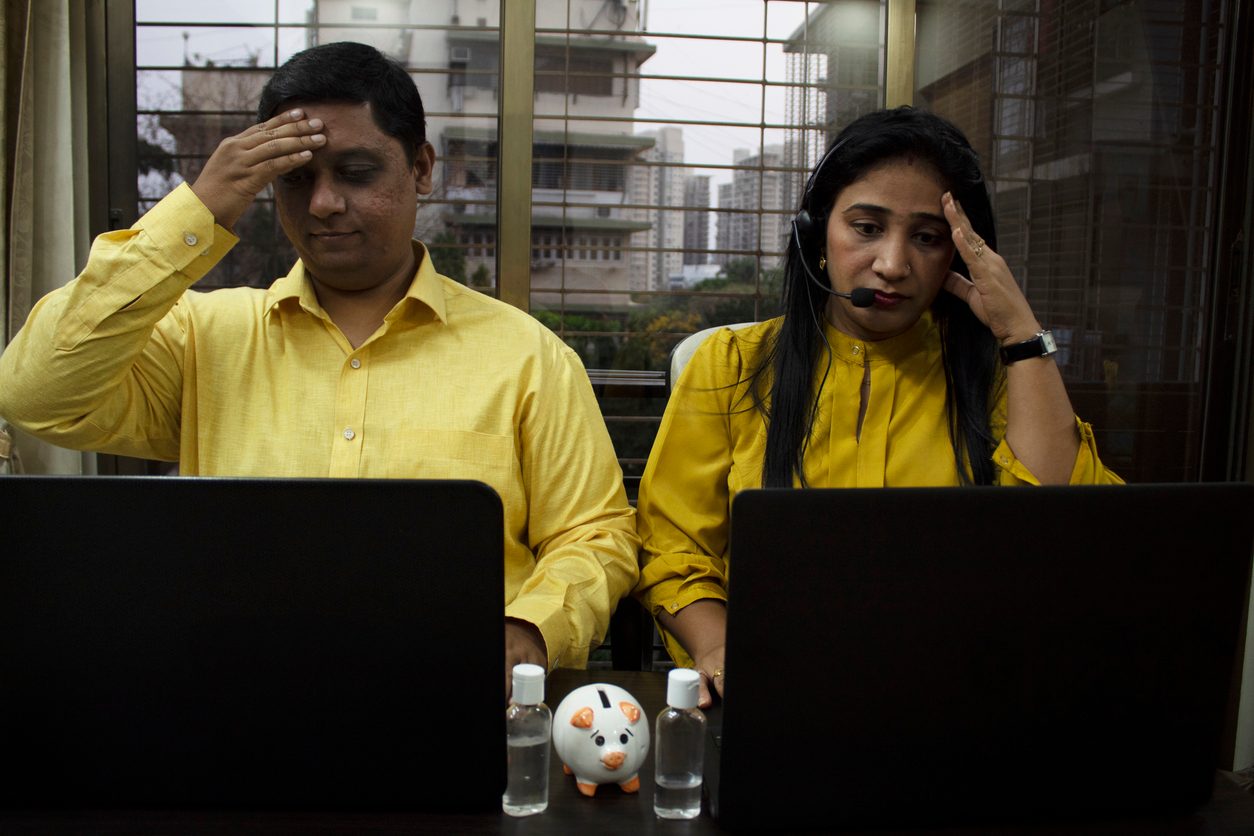 Couple disappointed while working on laptop