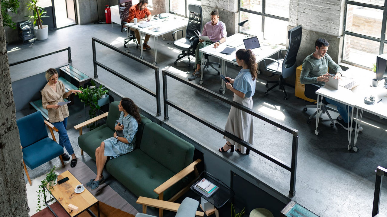 A group of people sitting at desks in an office.