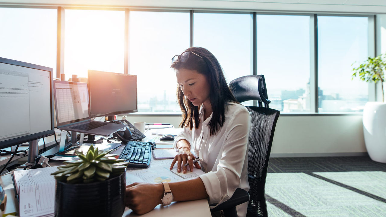 A woman working at her desk in an office.