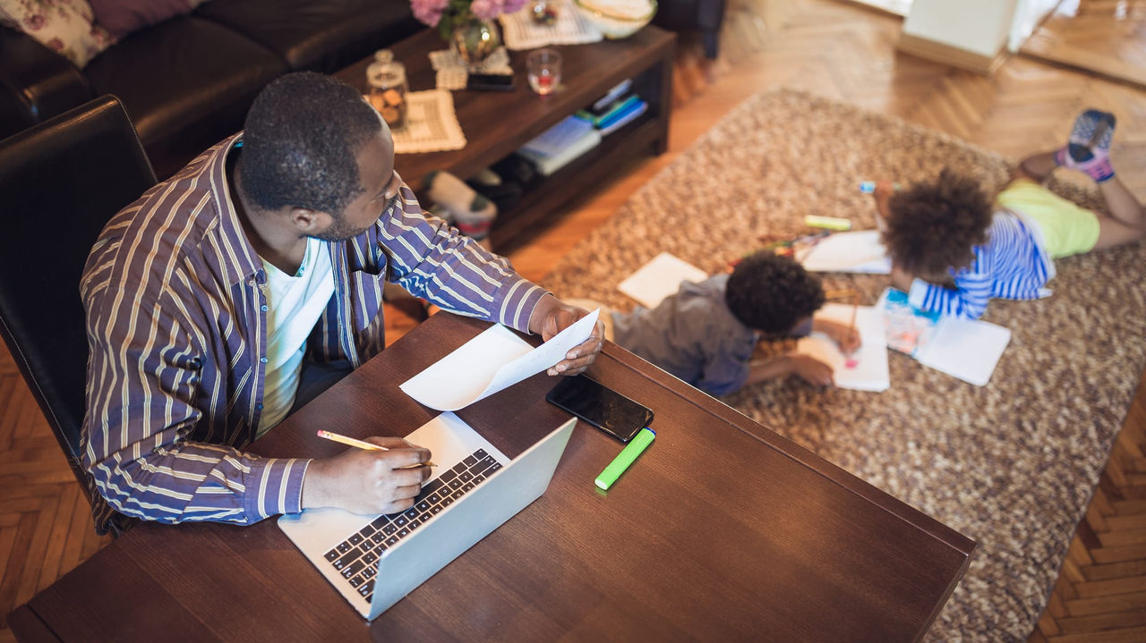 A man working on a laptop in his living room.