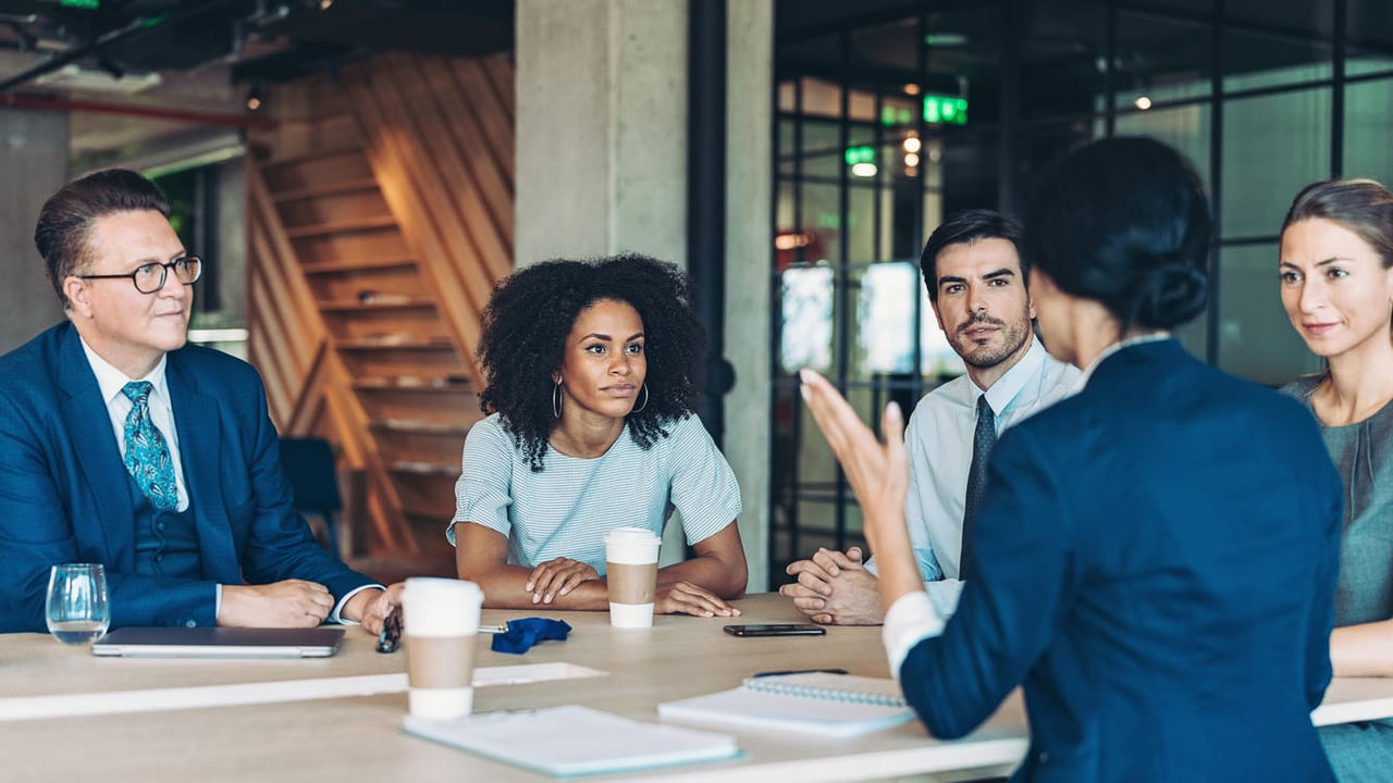 A group of business people having a meeting in a conference room.