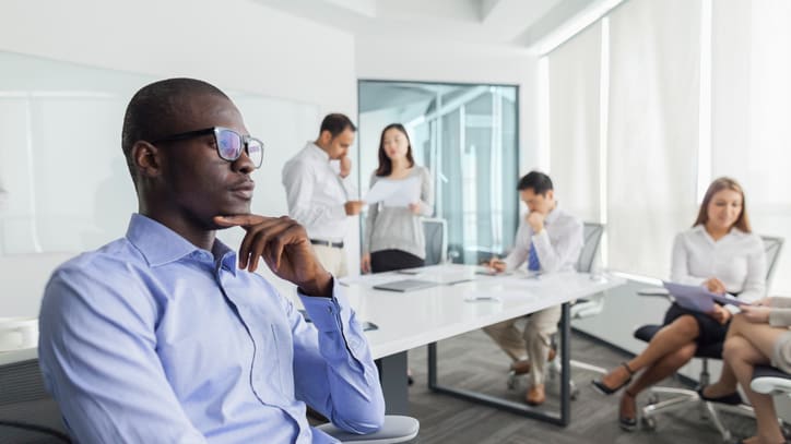 A businessman sitting in a chair in an office.