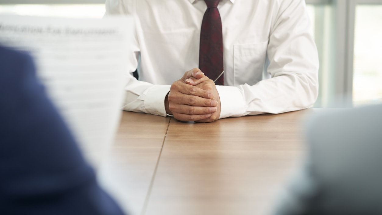 A businessman sitting at a table in a meeting.