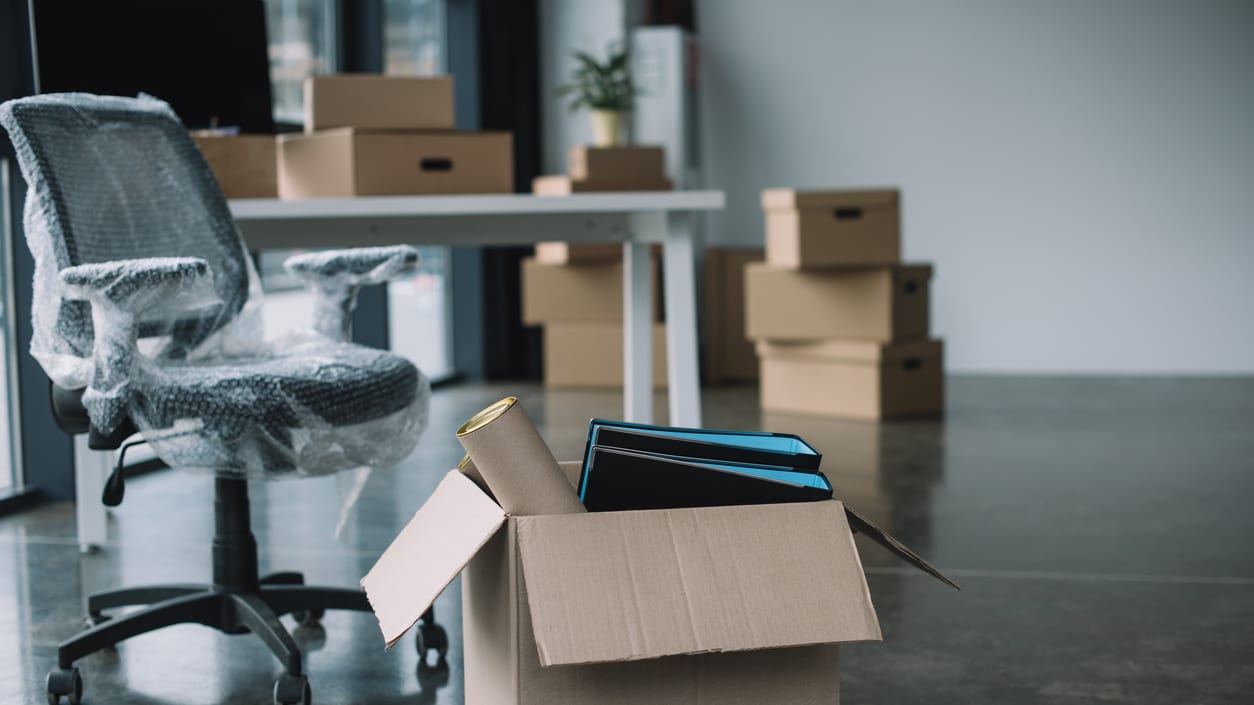 An office with a desk and a box in front of it.