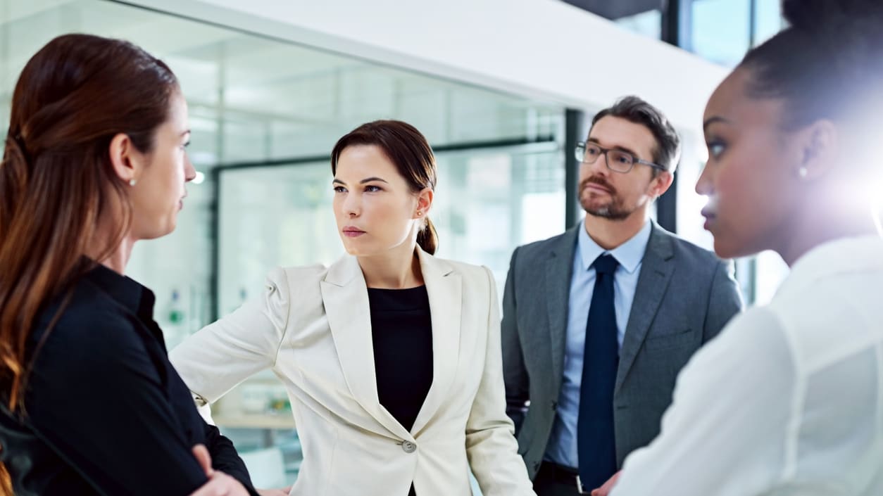 A group of business people talking in an office.