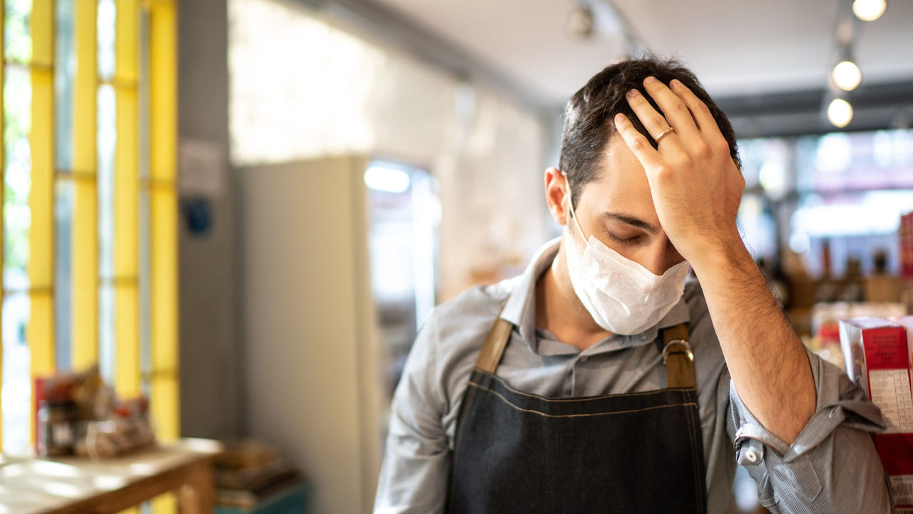 A man wearing a face mask in a grocery store.