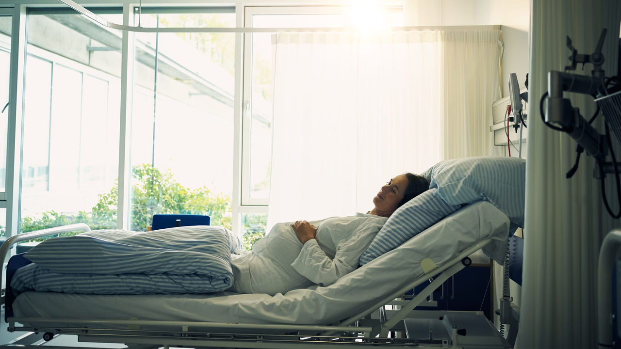 A woman is laying in a hospital bed.