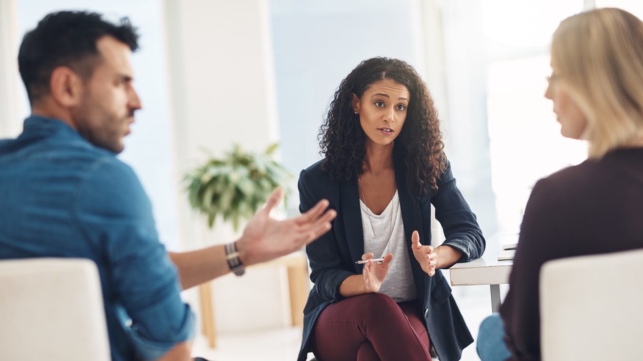 A group of people talking in a meeting room.