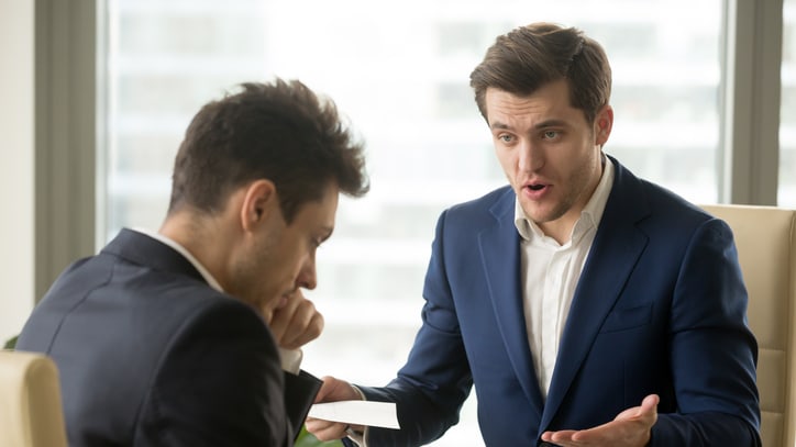 Two businessmen having a discussion in an office.