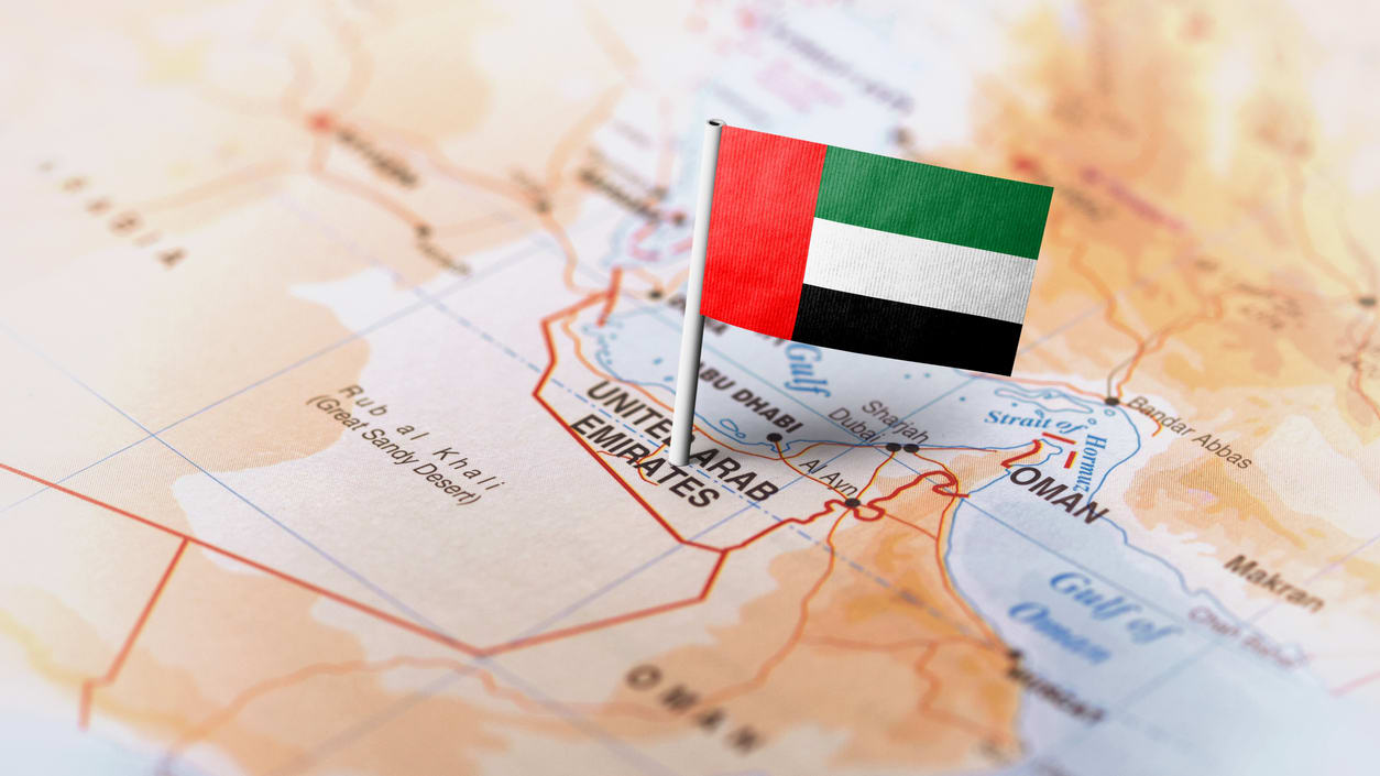 The flag of uae is pinned on a map.