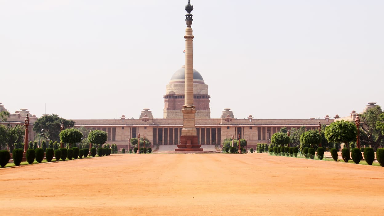 A large building with a statue in front of it.