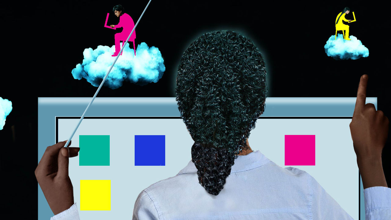 A woman is pointing at a computer screen with colorful clouds in the background.