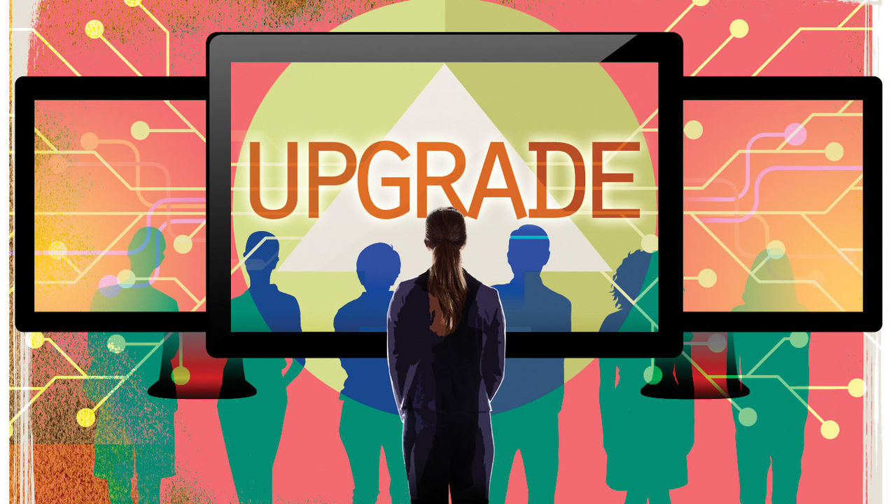 An image of a person looking at a screen with the word upgrade.
