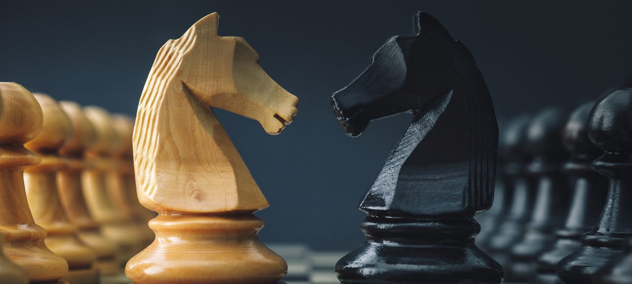 Chess Knights face off on a board