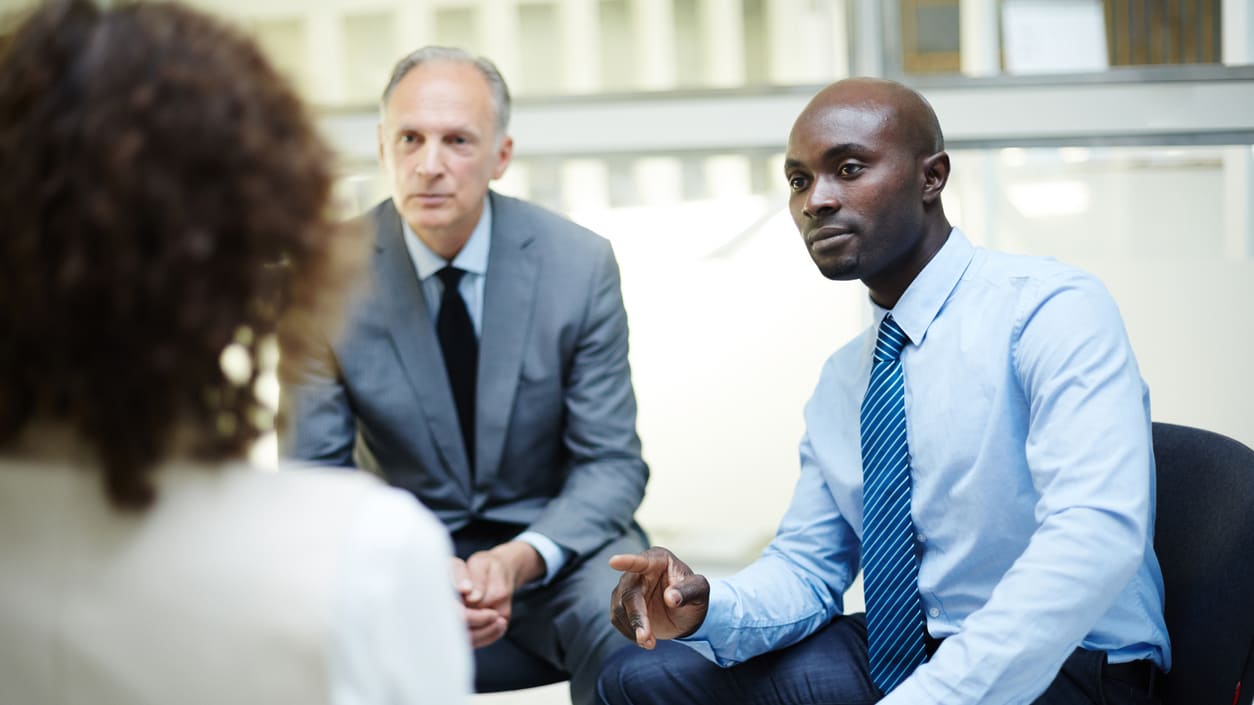 A group of business people talking in an office.