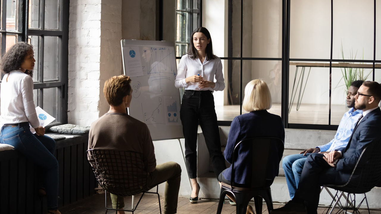 A group of people sitting in a meeting room.