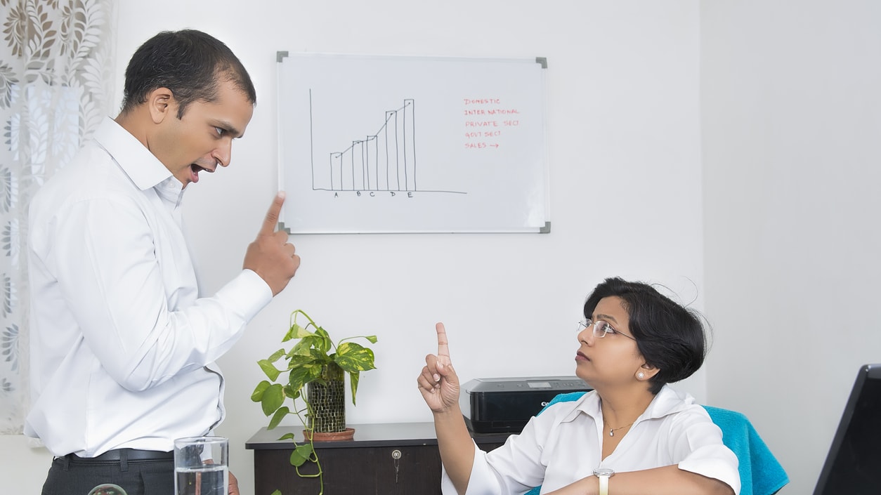 A man and a woman arguing in an office.