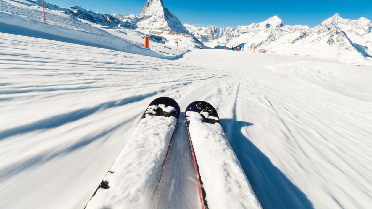A pair of skis on a snow covered slope.