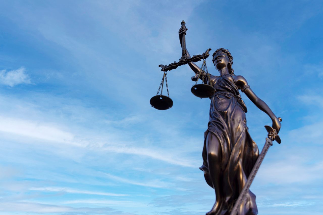 A statue with a scale symbolizing justice