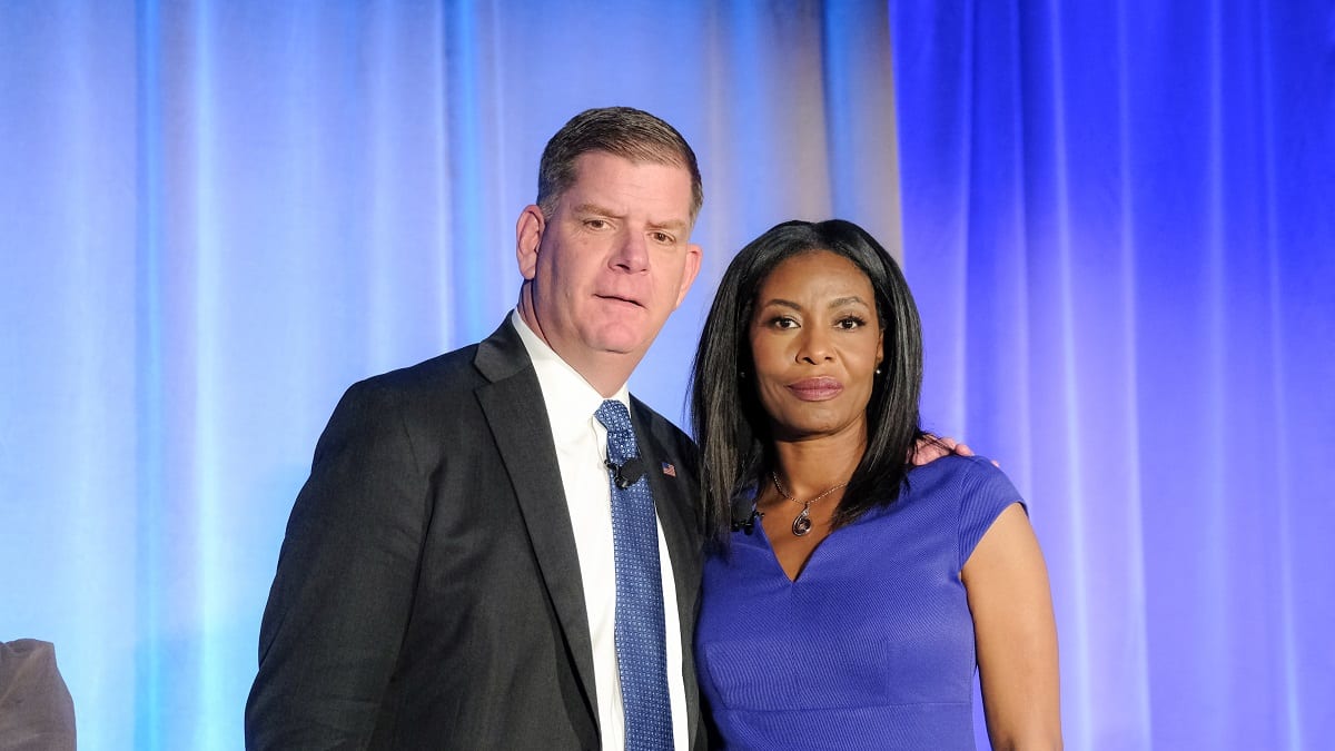 A man and woman standing next to each other at an event.